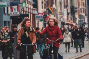 Two lady's riding their bikes on the street by Sam te Kiefte - Unsplash